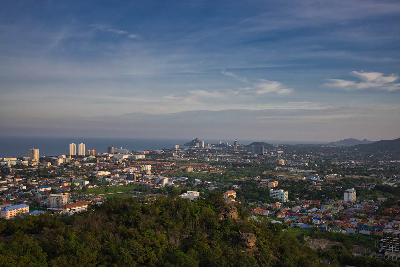 Panoramic view of Hua Hin city with the Gulf of Thailand in the background, captured from a hilltop vantage point.