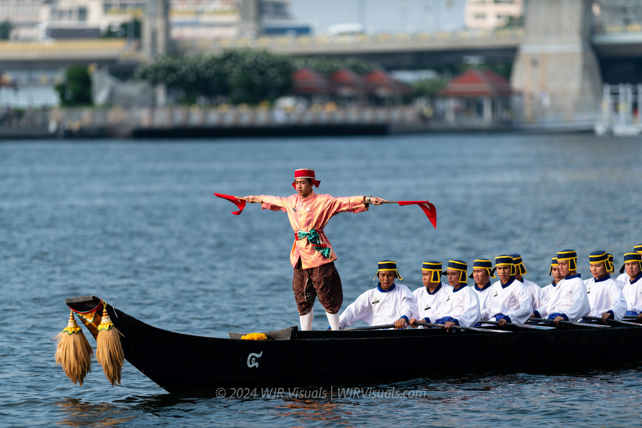 Royal barge crew member signaling during Chao Phraya River procession